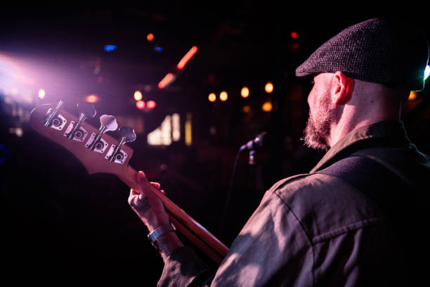 istock Mature man singing and playing guitar on a live concert 2159707591