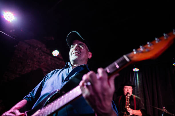 istock Mature man playing guitar on performance at nightclub 2159707697
