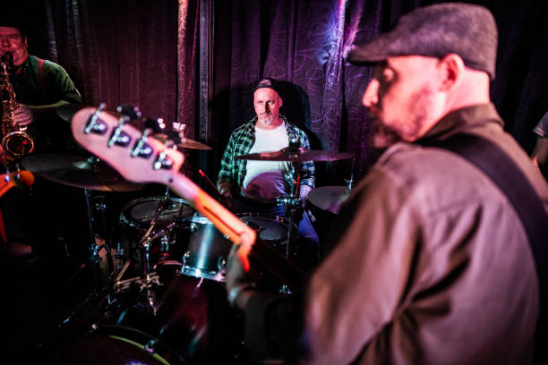 istock Mature man playing drum kit with band on a live concert 2159707777