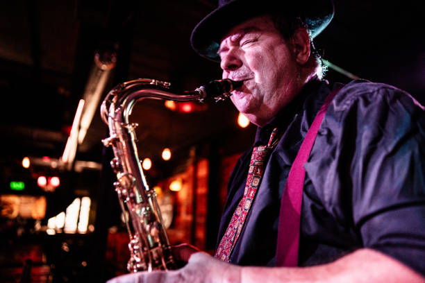 istock Senior musician playing saxophone at nightclub 2159707910