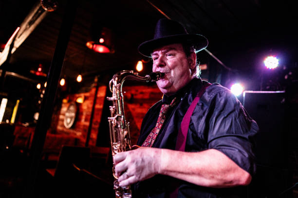 istock Senior musician playing saxophone at nightclub 2159707913