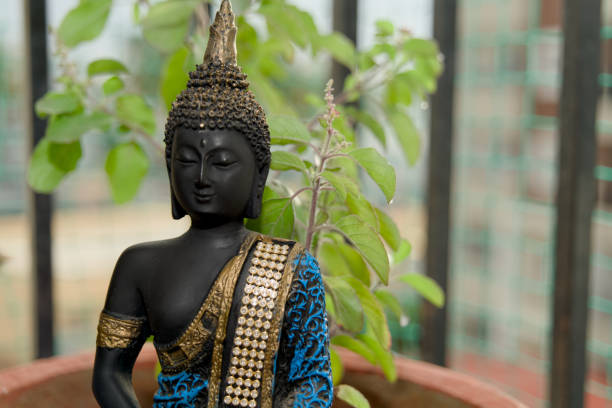 Buddha with candlelight and decoration on golden fabric - selective focus