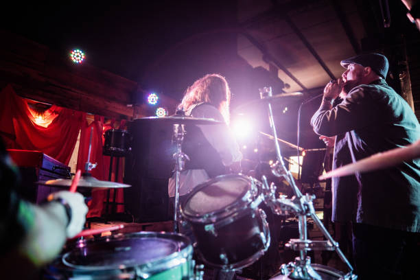 istock Rock band playing and singing during show at night club 2159708295
