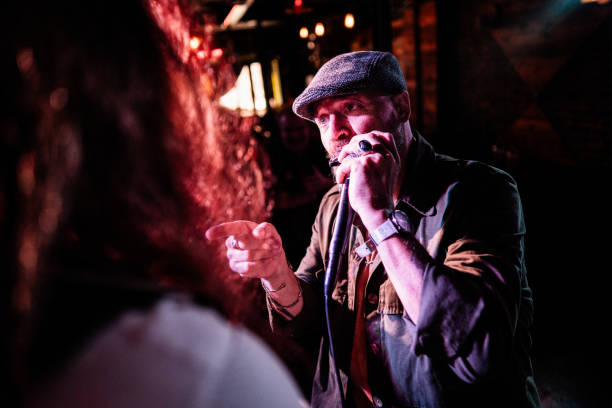 istock Mature man playing the harmonica on live concert 2159708306