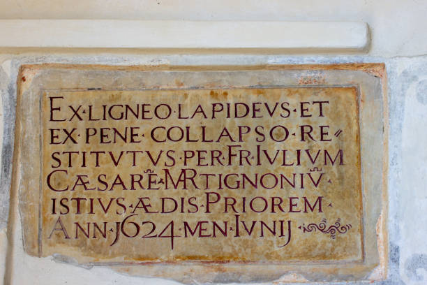 Old marble placard with religious Latin text in a monastery, Lake Maggiore, Italy