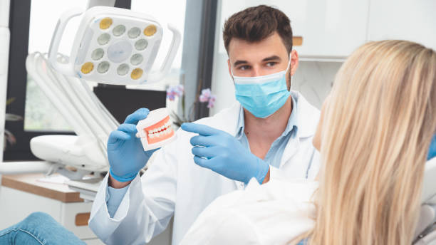 istock Dentist showing jaw model. Dental treatment 2159709167