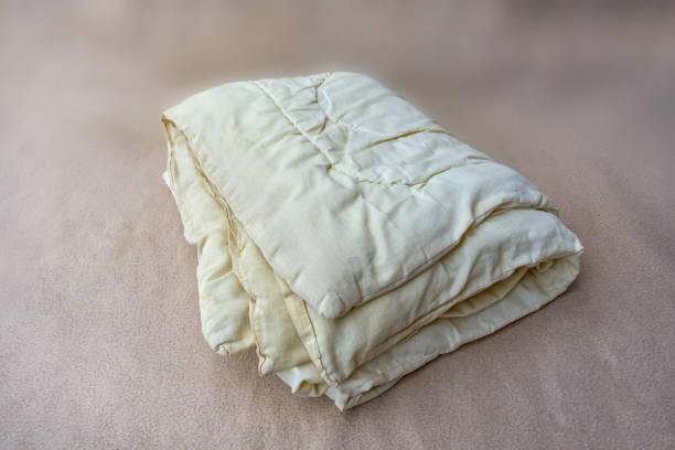 istock Old yellow bed duvet full of mites. 2159709947