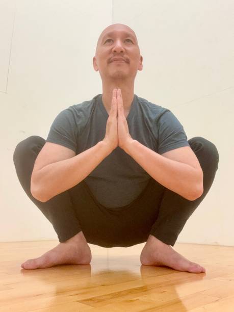 istock Filipino guy squatting, stretching 2159710009