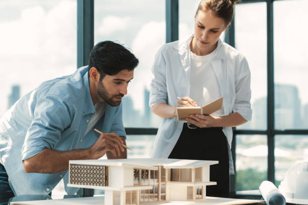 istock Smart architect engineer team working together to measure house model. Tracery. 2159712245