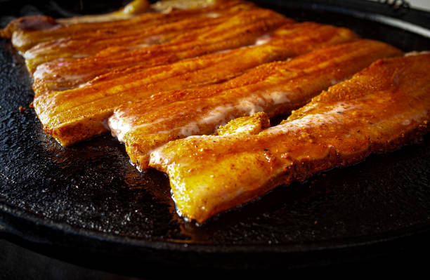 BBQ with pork belly on a steel plancha
