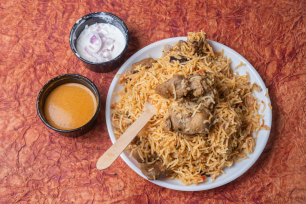 istock Indian mutton biryani dish served on white plate with raita and gravy. 2159712508
