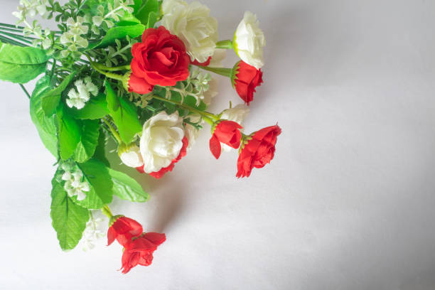 Red roses and white flowers isolated on a white background.