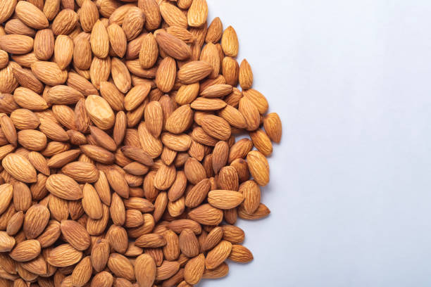 istock Top view of almonds on white background with copy space 2159713729