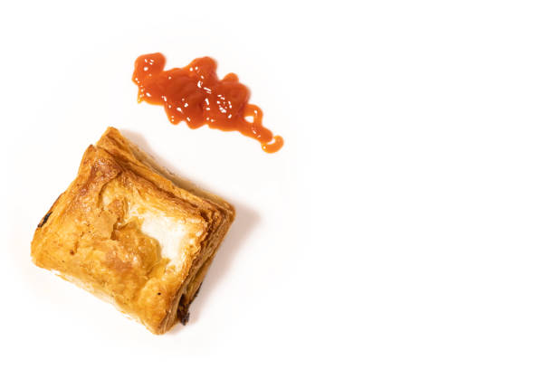 Veg puff pastry with ketchup isolated on white background with copy space