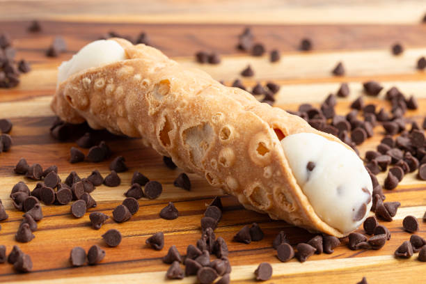 istock Chocolate Chip Marscapone Cheese Filled Cannoli Pastries on a Wooden Table 2159715059