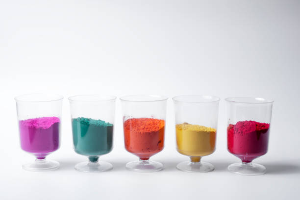 istock Multicolored holi powder sand in measuring cup row isolated on white background. 2159715345