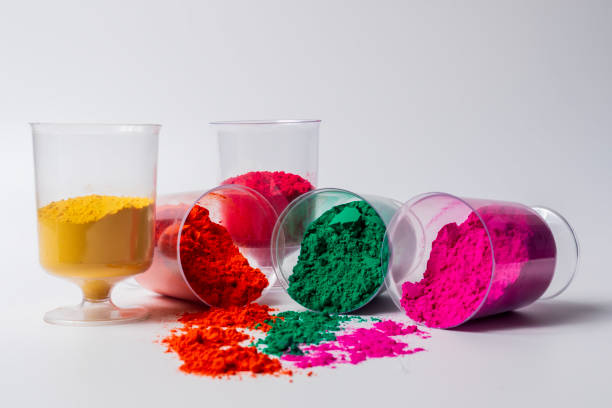 istock Colorful holi powder in a glass container isolated on white background. 2159715437