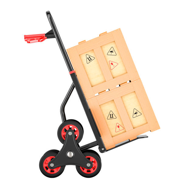 Trolley cart with fragile cardboard boxes outside garage door wide shot selective focus