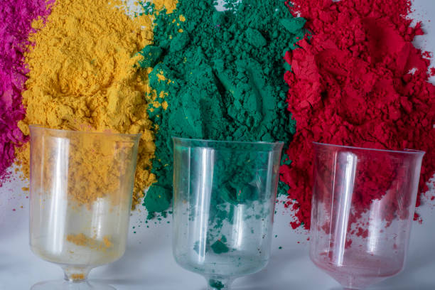 istock Colorful holi powder with empty glass vase on white background. 2159716583