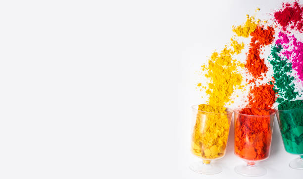 istock Colorful holi powder in a plastic containers on white background with copy space. 2159716642