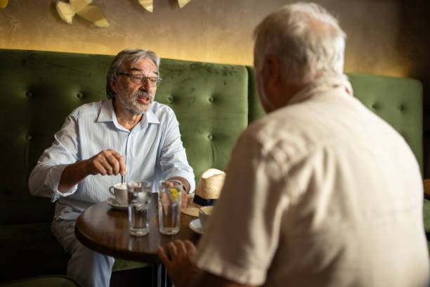 istock Old friends sitting in cafe 2159718036