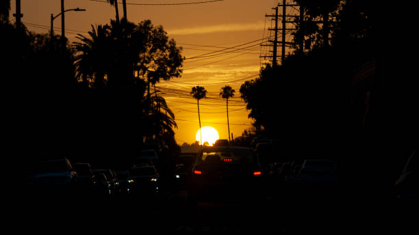 istock The sun sets in front of a stopped car 2159719156