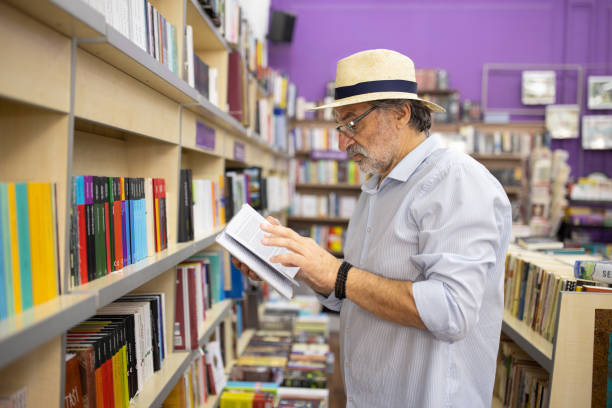 istock Man reading at the bookstore 2159719293