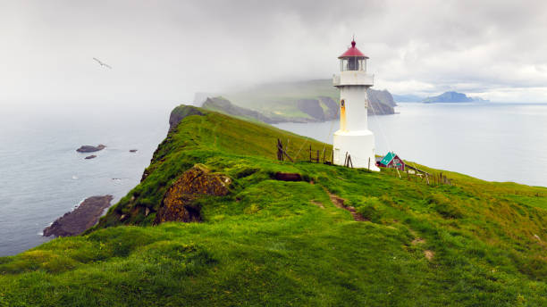 istock Old white lighthouse on the Mykines island 2159719883