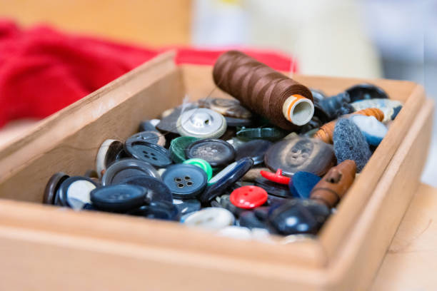Color image of anonymous hands searching in a group of buttons.