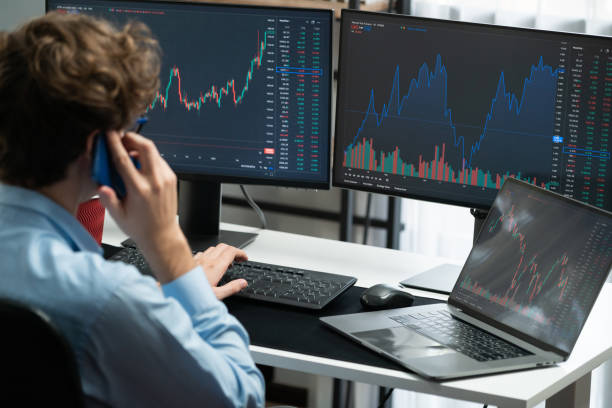 istock Stock trader discussing on smartphone, looking financial exchange. Gusher. 2159721208