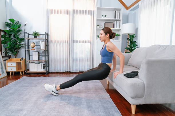 istock Energetic and determination asian woman push up on sofa. Vigorous 2159721305