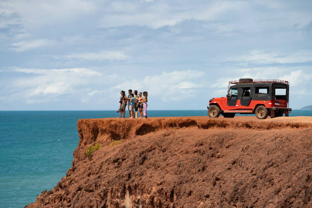 istock Group of tourists on the cliff on the beach 2159729540