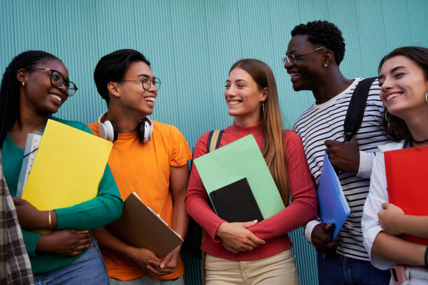 istock Multiracial student friends gathering after class, talking cheerfully isolated in a blue background. 2159732997