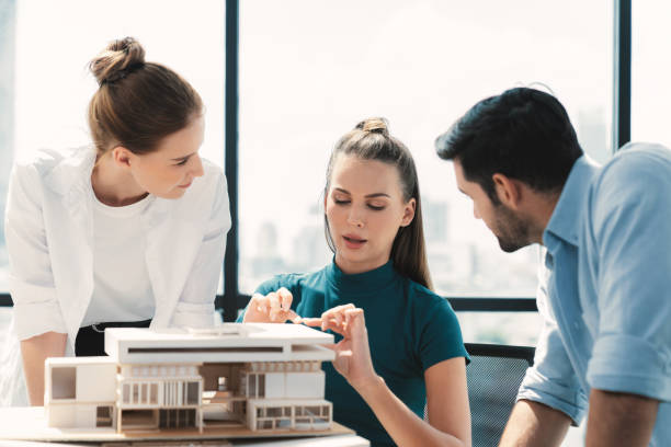 istock Professional architect team working together to design house model. Tracery. 2159733634