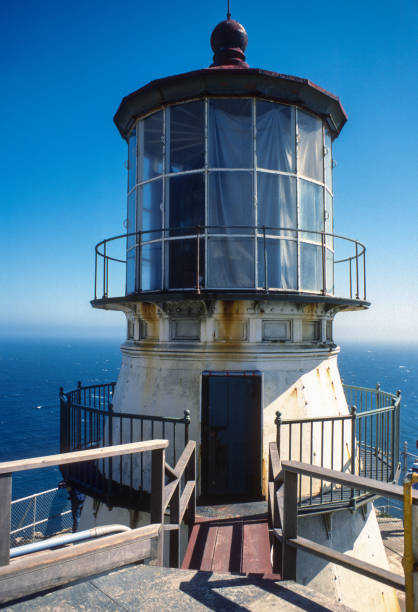 Mendocino County, California, USA - June 2, 2025: A visitor takes a photo of the historic Point Cabrillo Light Station at Point Cabrillo Light Station State Historic Park by the Pacific Ocean on the Northern California coast.