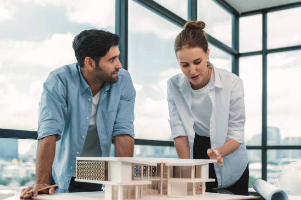 istock Smart architect engineer team working together to measure house model. Tracery. 2159737010