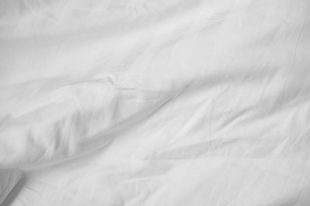 istock Abstract White Bedding Sheets or White wrinkled fabric background texture and Texture with copy-space :Creased or wrinkled white fabric,Soft focus 2159739546