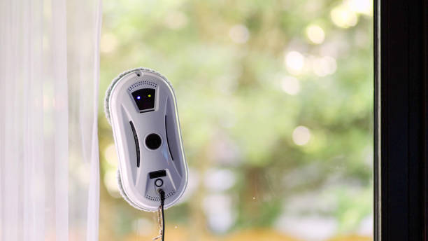 istock Window cleaning robot on glass with green background. 2159741639