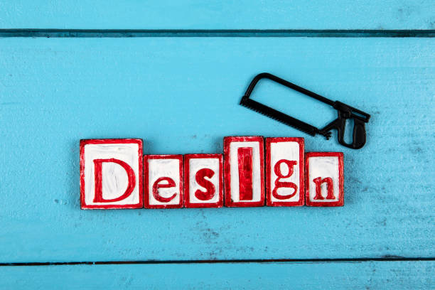 DESIGN. Miniature saw on a blue wooden background. construction and carpentry concept.