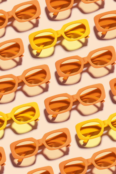 istock Pattern of Trendy sunglasses with Yellow Frame on peach background, beach vibes, summertime mood, sunlight shadow, Summer vacation, summer rest concept. Minimal style layout of eyeglasses 2159747292