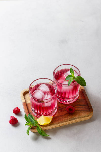 istock Raspberry cocktail with ice in a glass on a light background 2159750239