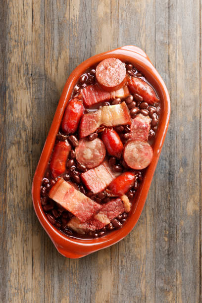 istock brazilian feijoada in ceramic bowl isolated on rustic wooden background. Copy space 2159750364