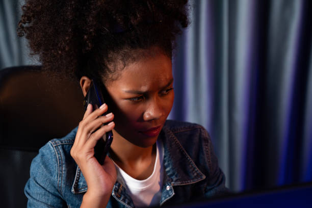 istock Working African woman concentrating laptop and making a phone call. Tastemaker. 2159752545
