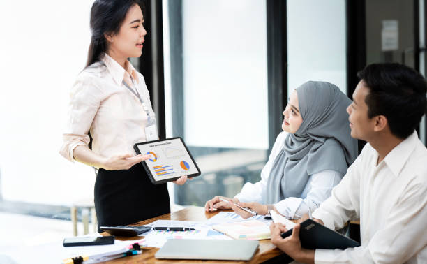 istock Asian team of business people working with business data analytics on laptop at office, Business presentation or seminar concept. 2159754461
