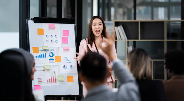 istock Group of Asian businessmen are presenting graphs on a whiteboard. 2159755806
