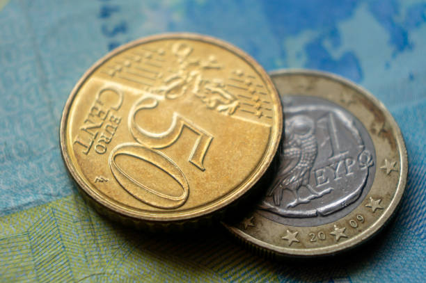 istock Eurozone currency, coins lie on banknotes close-up 2159755847