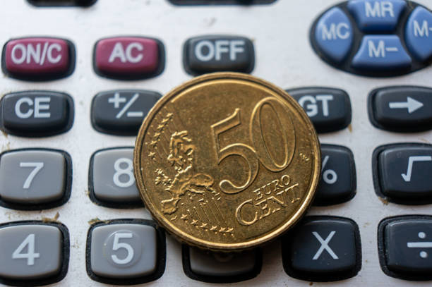 Eurozone currency, coins lie on a calculator close-up. High quality photo