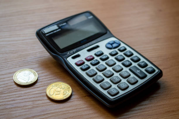 istock Eurozone currency, coins lie next to a calculator 2159757692