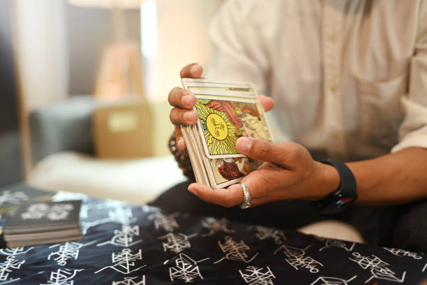 istock Fortune teller holding tarot cards deck. Astrologists, forecasting and divination concept 2159759395