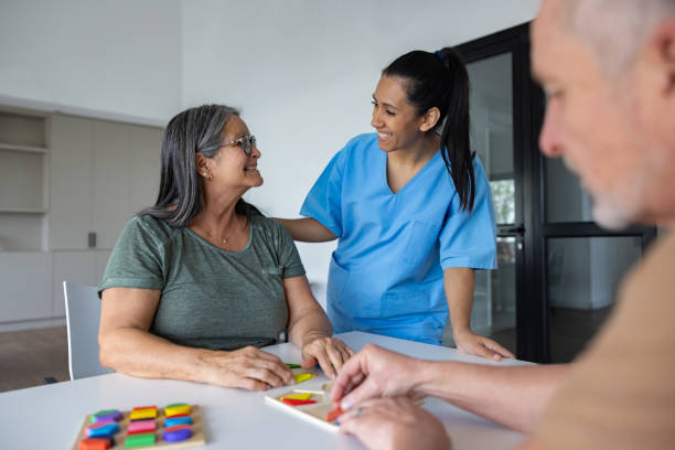 istock Occupational therapist assisting a woman playing with sensory perception games 2159759622